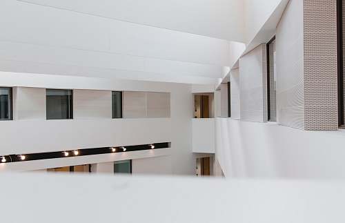 interior design photography of white concrete building during daytime indoors